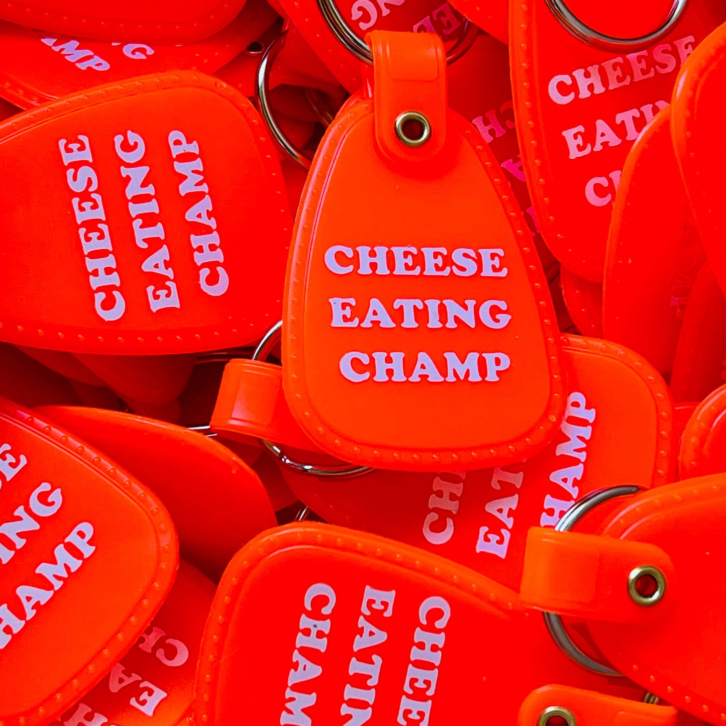 Cheese Eating Champ Saddle Keychain